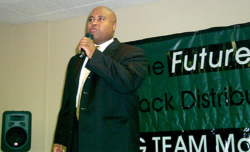 Delxino speaking on stage, Los Angeles, California Black Business Seminar