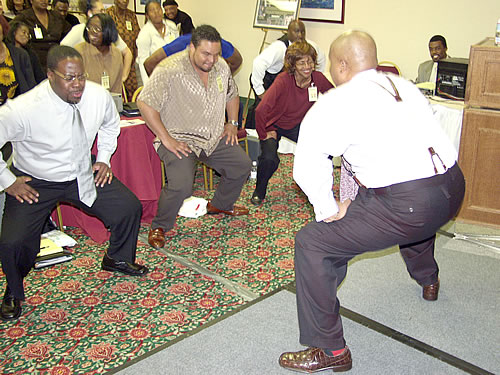 Delxino leading audience in aerobic warm up exercise, Los Angeles, California Black Business Seminar