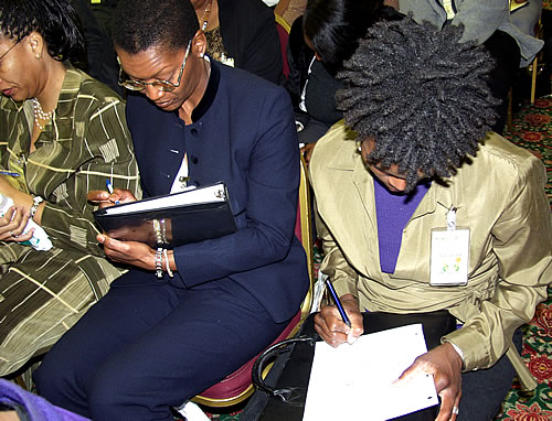 Sisters taking notes, Los Angeles, California Black Business Seminar